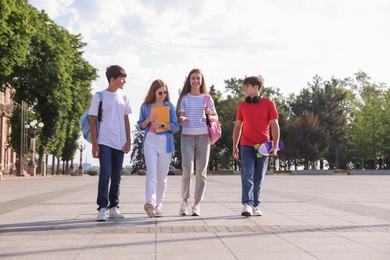 Photo of Group of teenagers walking together on city street