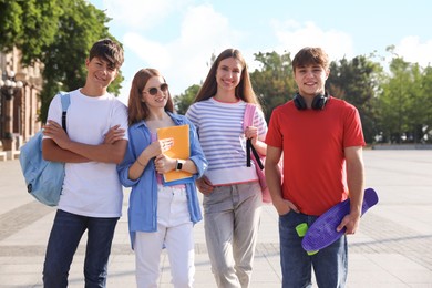 Photo of Group of teenagers walking together on city street