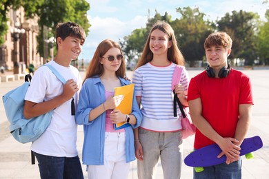 Photo of Group of teenagers walking together on city street