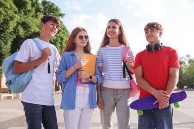 Photo of Group of teenagers walking together on city street
