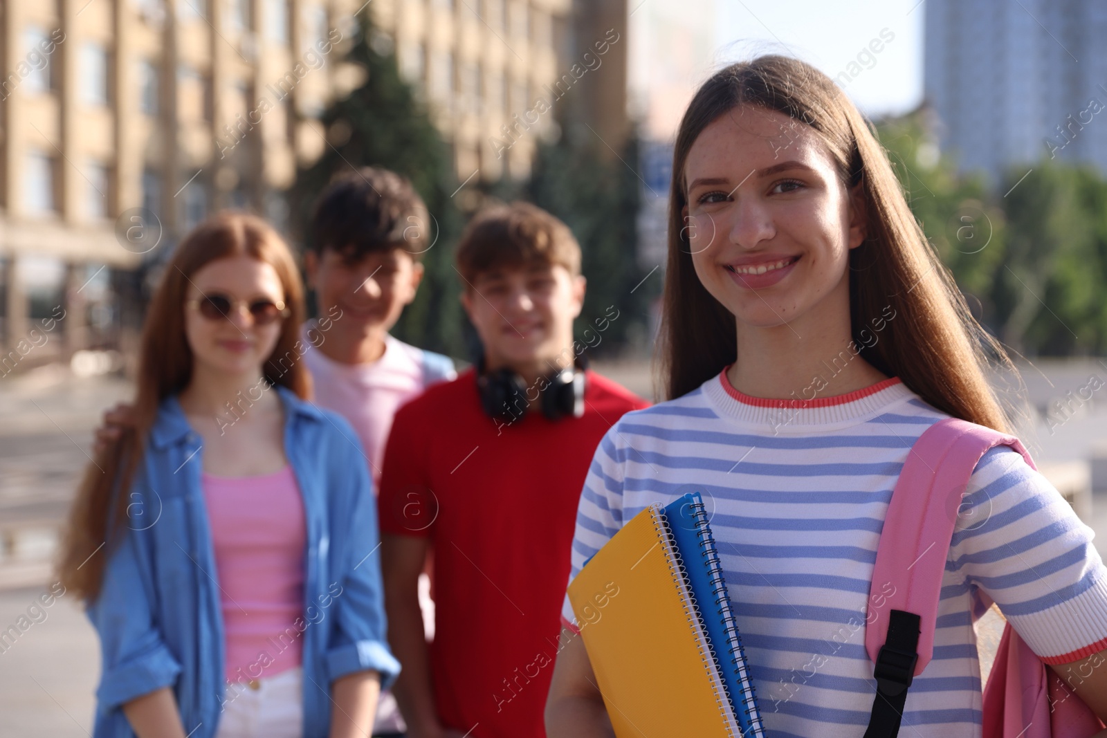 Group of teenagers walking together on city street, selective focus Photo of Group of teenagers walking together on city street, selective focus