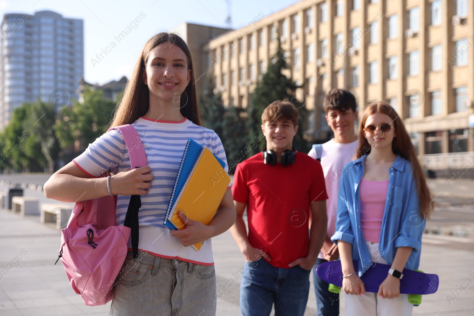 Group of teenagers walking together on city street, selective focus Photo of Group of teenagers walking together on city street, selective focus