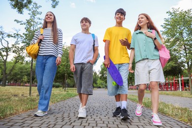 Photo of Group of teenagers spending time together outdoors, low angle view