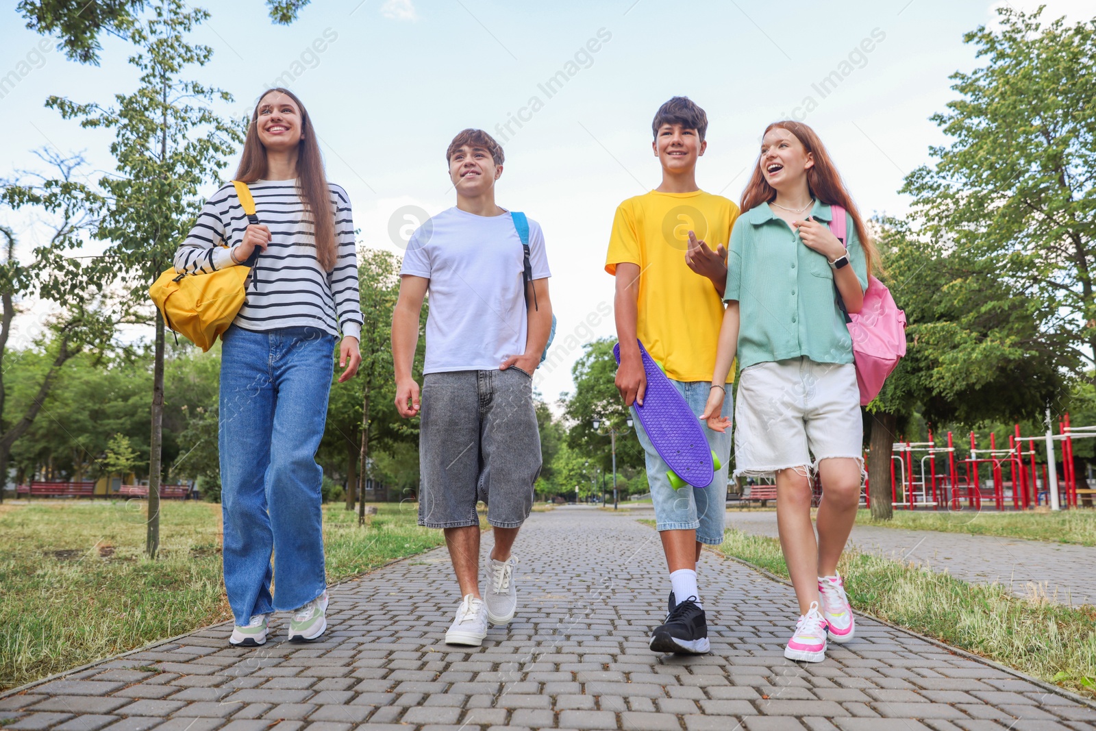 Group of teenagers spending time together outdoors, low angle view Photo of Group of teenagers spending time together outdoors, low angle view