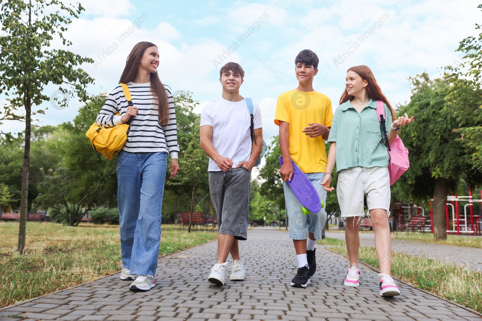 Group of teenagers spending time together outdoors, low angle view Photo of Group of teenagers spending time together outdoors, low angle view
