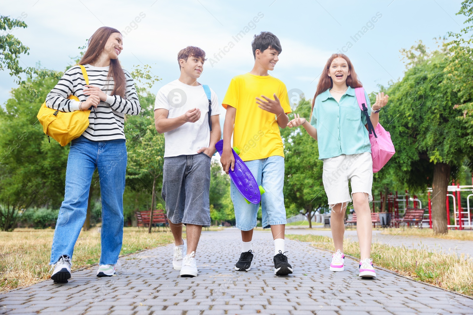 Group of teenagers spending time together outdoors, low angle view Photo of Group of teenagers spending time together outdoors, low angle view