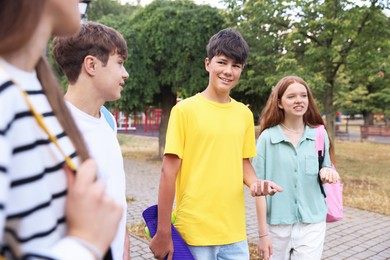 Photo of Group of teenagers spending time together outdoors