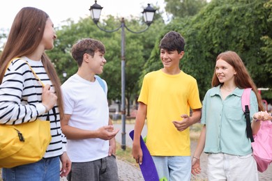 Photo of Group of teenagers spending time together outdoors