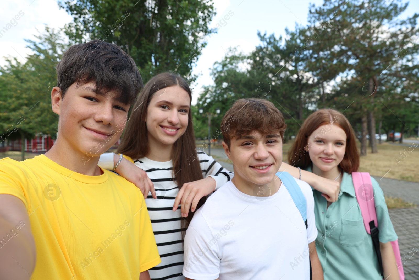 Group of teenagers taking selfie in park Photo of Group of teenagers taking selfie in park