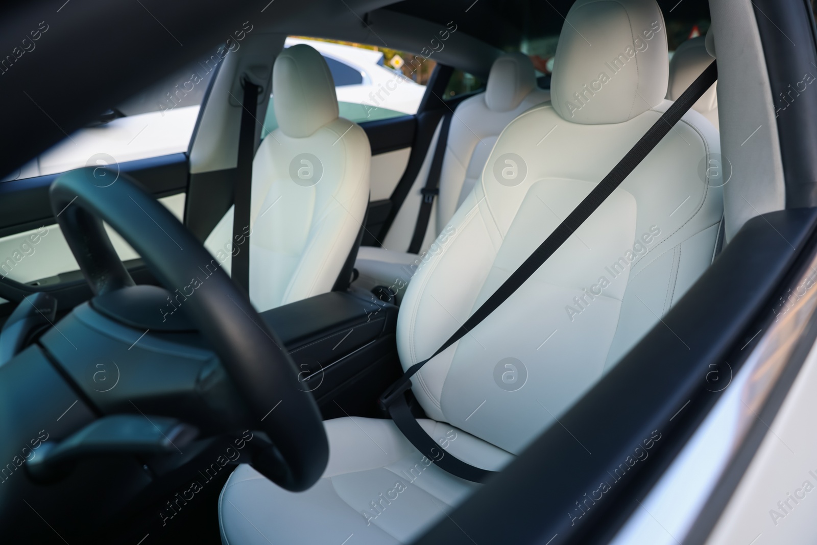 Modern car interior with seats and safety belts, view from outside Photo of Modern car interior with seats and safety belts, view from outside
