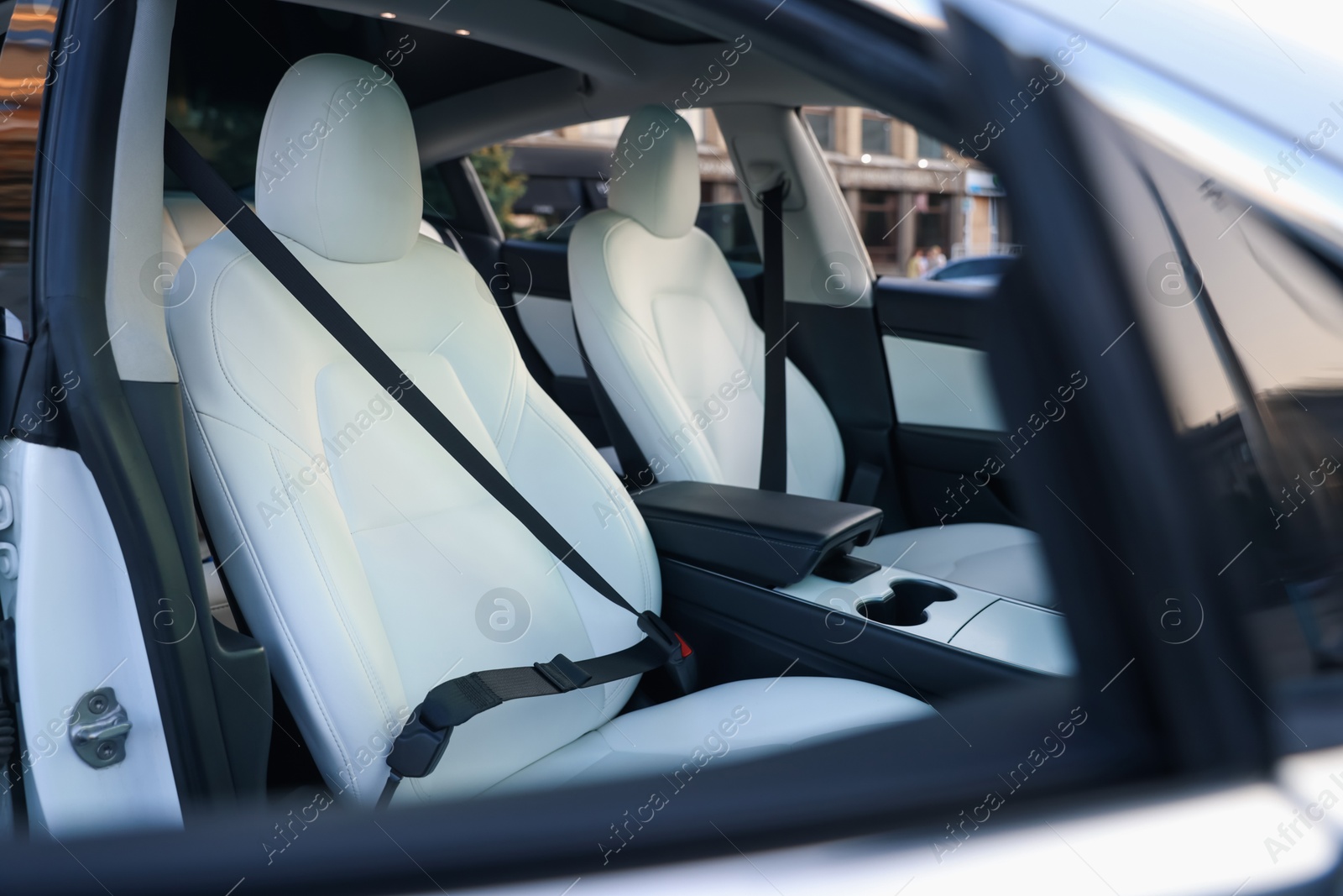 Modern car interior with seats and safety belts, view from outside Photo of Modern car interior with seats and safety belts, view from outside