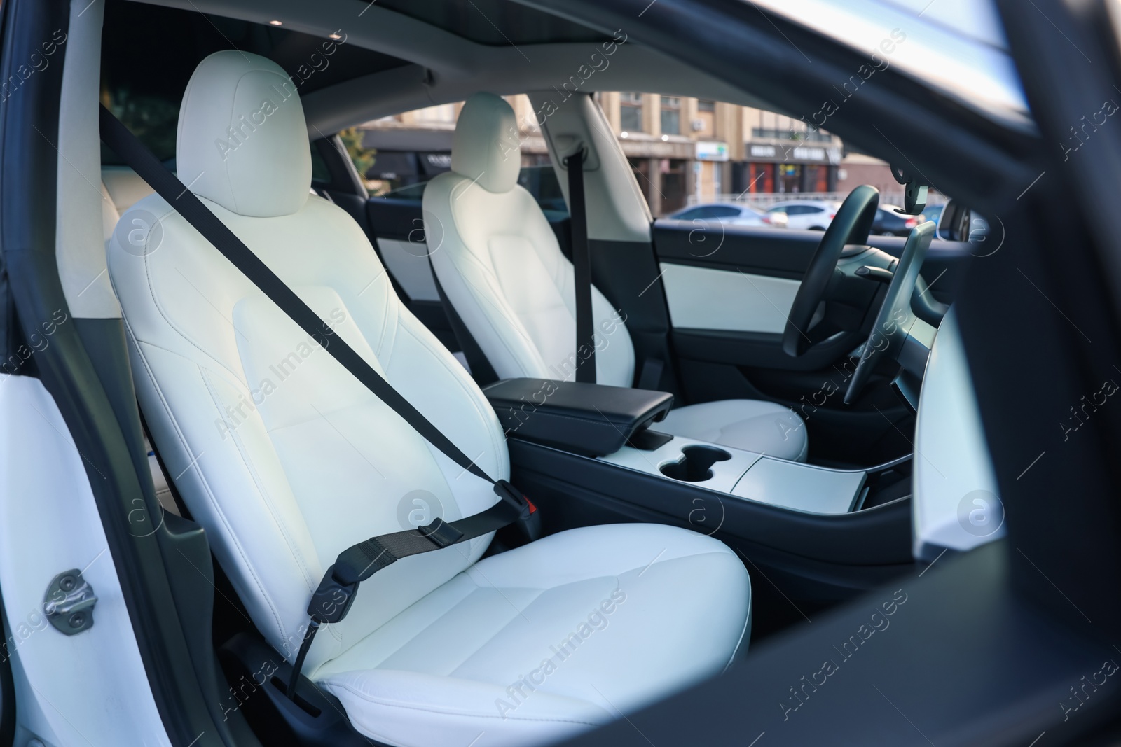 Modern car interior with seats and safety belts, view from outside Photo of Modern car interior with seats and safety belts, view from outside