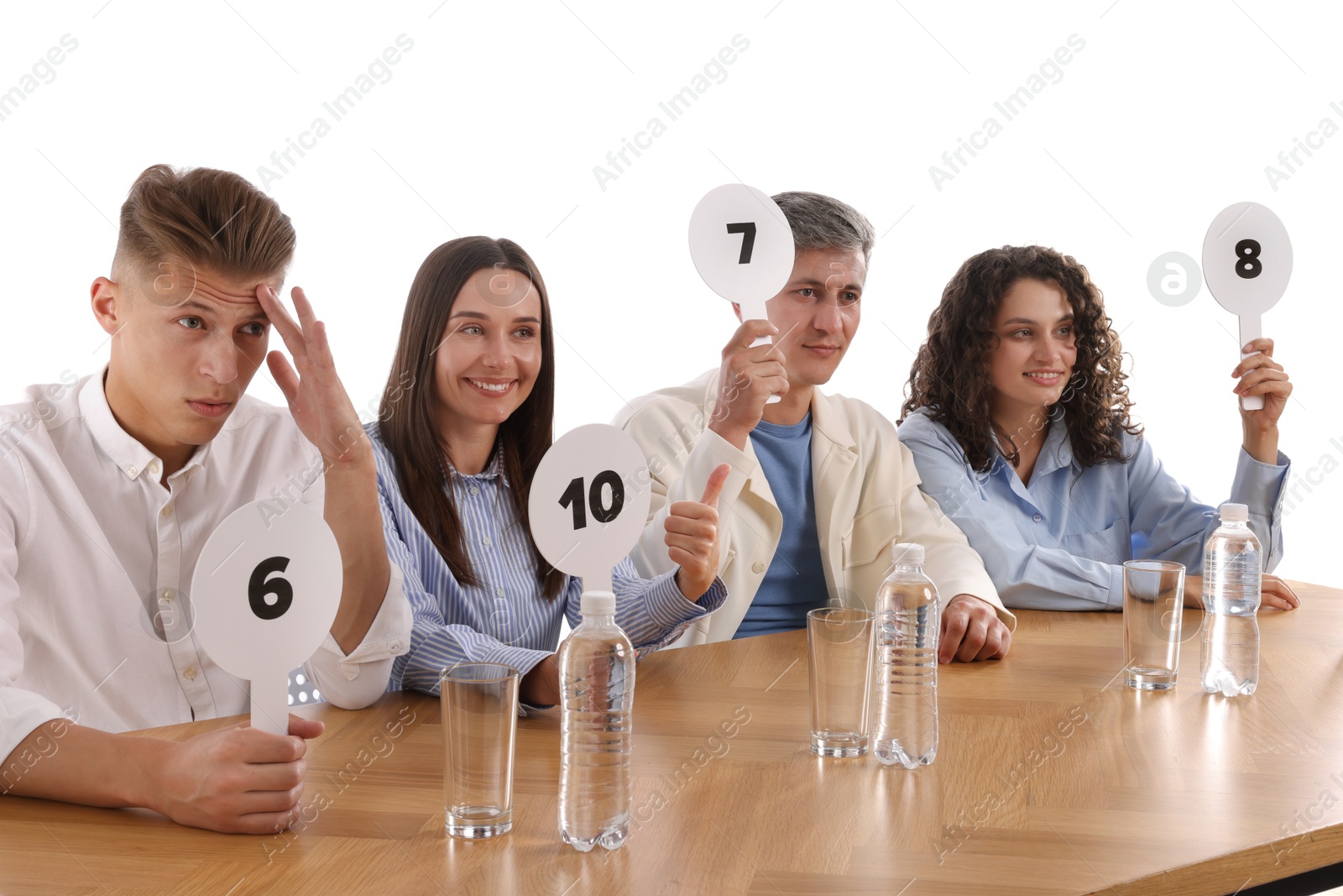 Panel of judges voting with score signs at table on white background Photo of Panel of judges voting with score signs at table on white background
