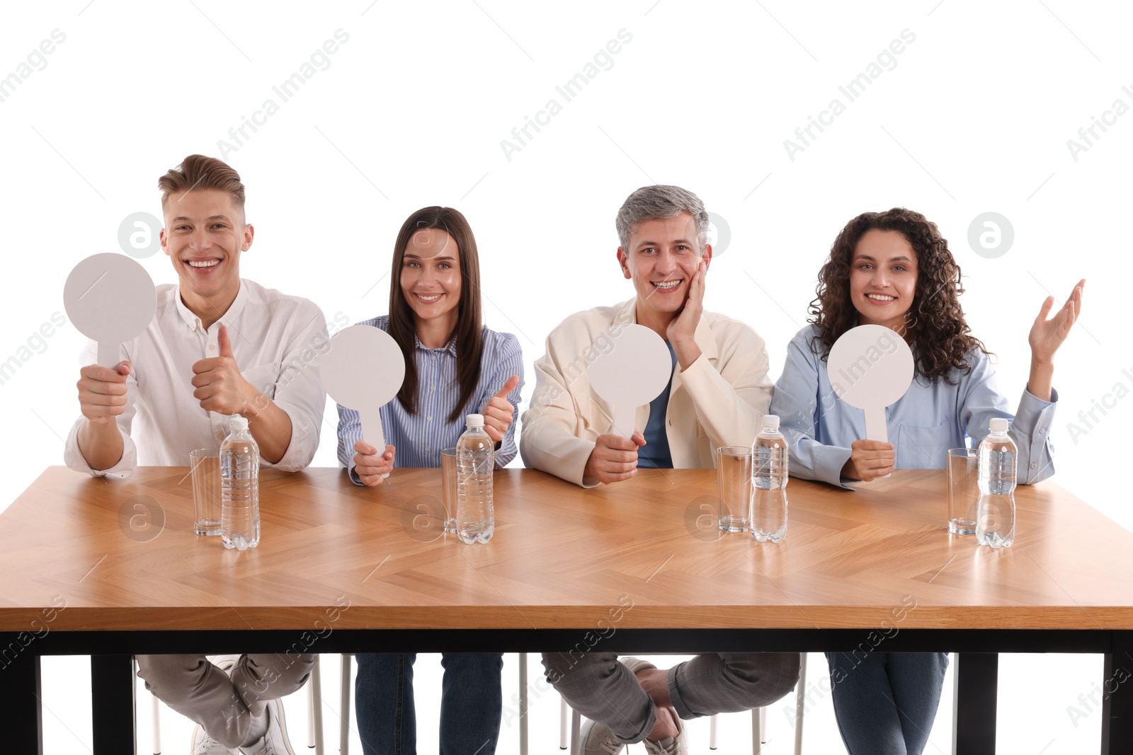Panel of judges with blank score signs at table on white background Photo of Panel of judges with blank score signs at table on white background