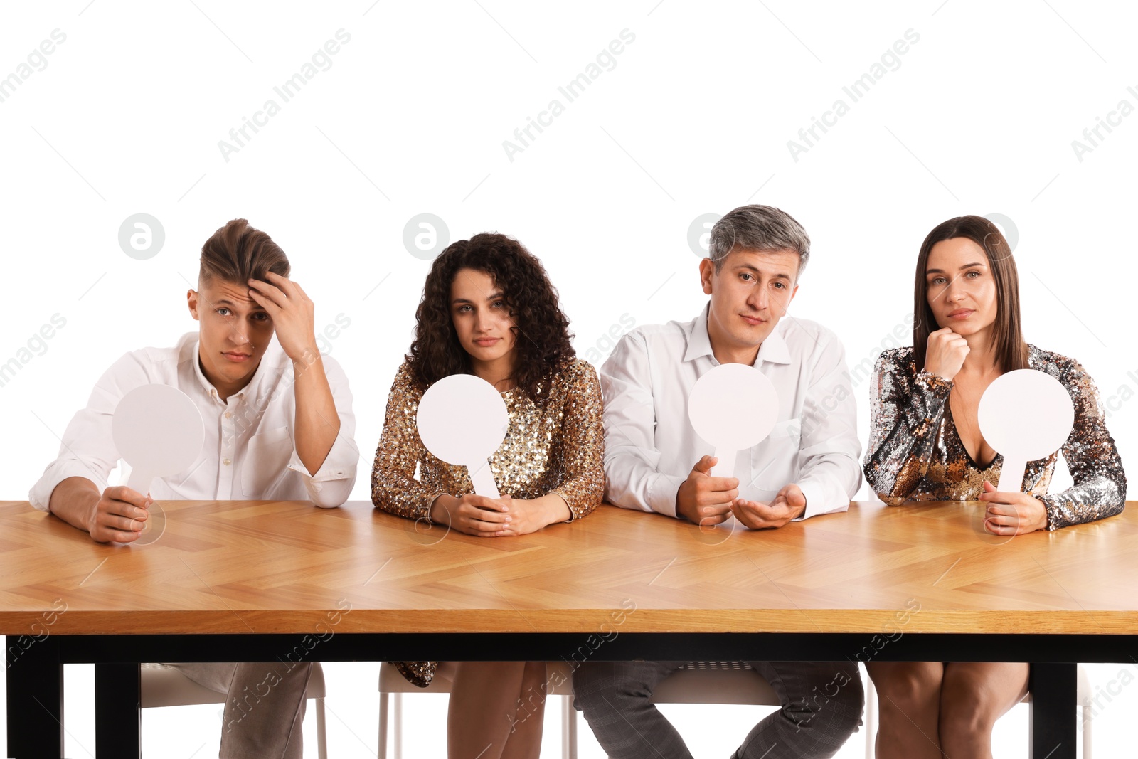 Panel of judges with blank score signs at table on white background Photo of Panel of judges with blank score signs at table on white background