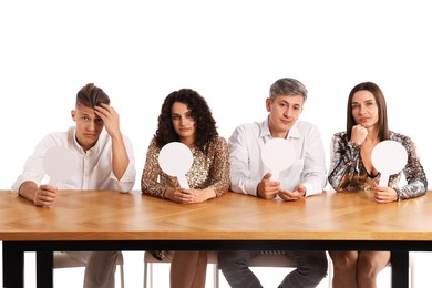 Photo of Panel of judges with blank score signs at table on white background