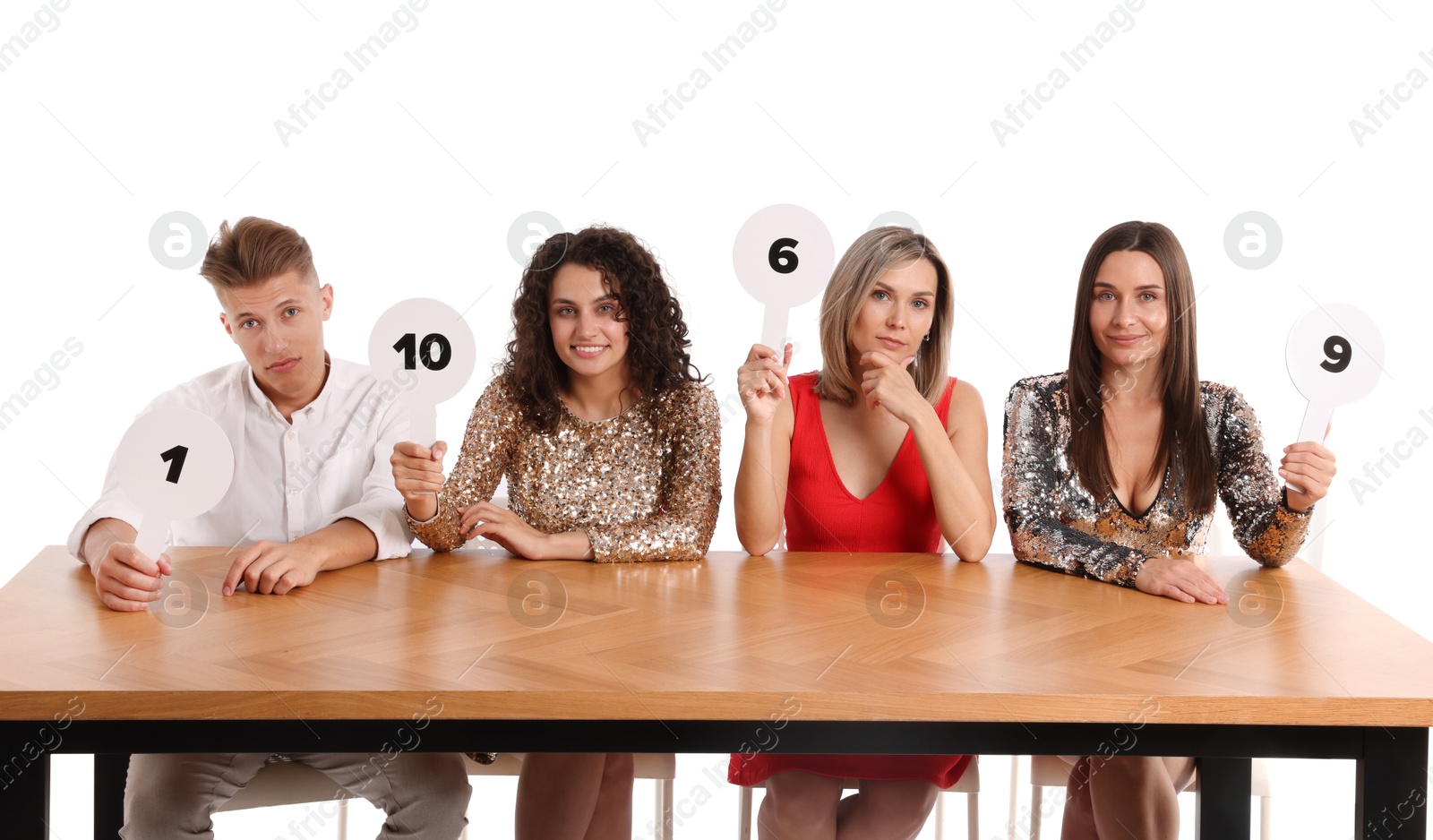 Panel of judges voting with score signs at table on white background Photo of Panel of judges voting with score signs at table on white background