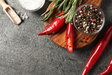 Photo of Different aromatic spices on grey table, flat lay. Space for text