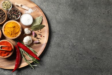 Photo of Different aromatic spices on grey table, top view. Space for text