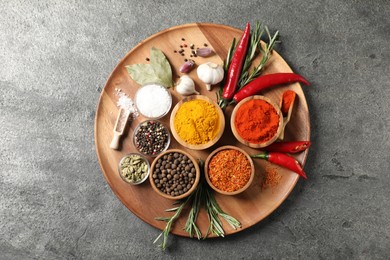 Photo of Different aromatic spices on grey table, top view
