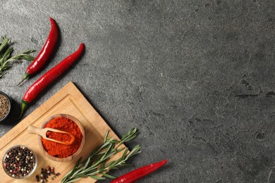 Photo of Different aromatic spices on grey table, flat lay. Space for text