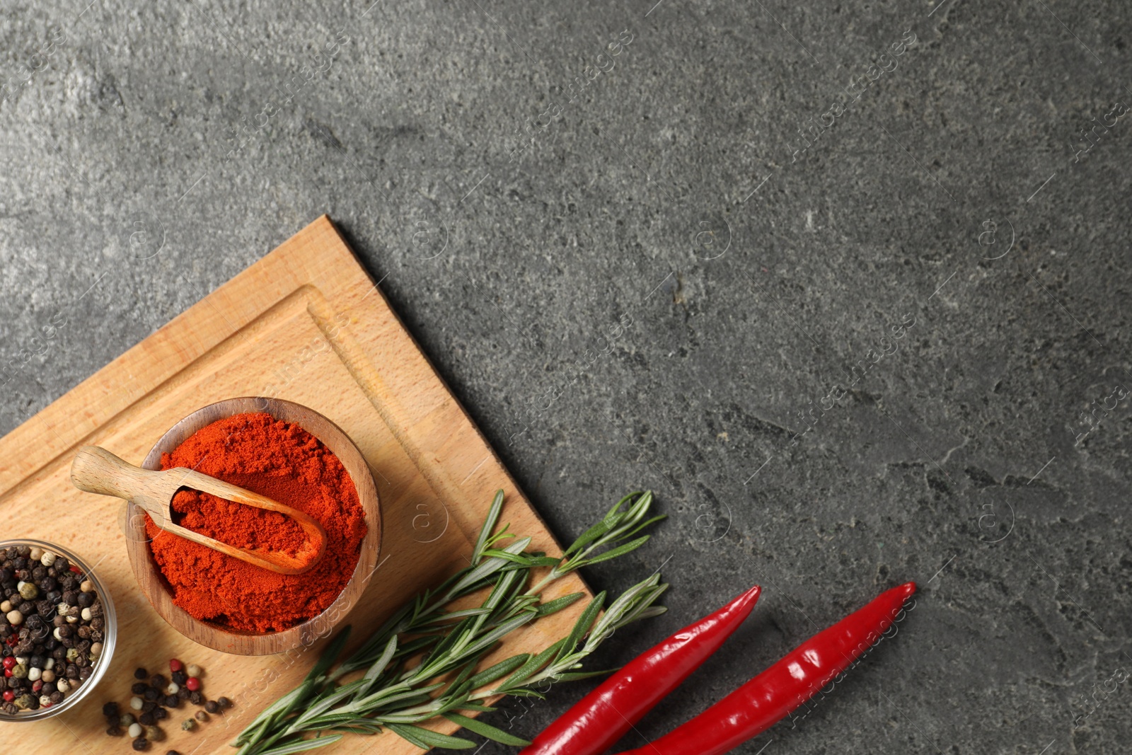 Different aromatic spices on grey table, flat lay. Space for text Photo of Different aromatic spices on grey table, flat lay. Space for text
