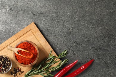 Photo of Different aromatic spices on grey table, flat lay. Space for text