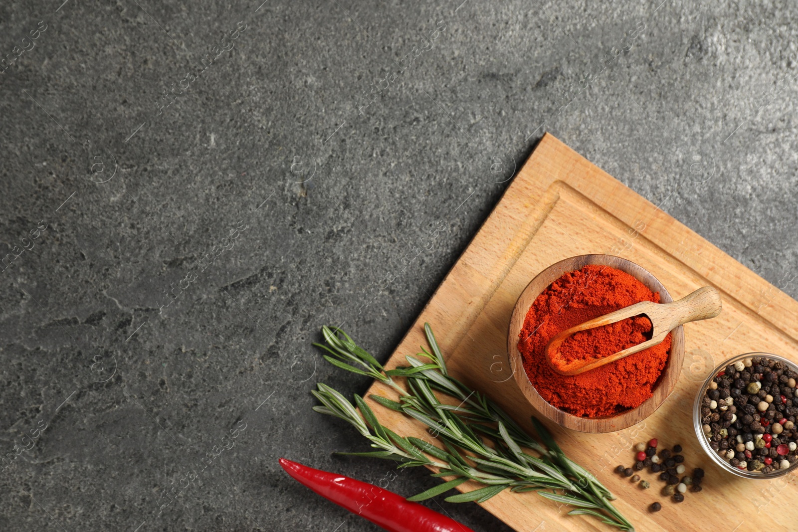 Different aromatic spices on grey table, flat lay. Space for text Photo of Different aromatic spices on grey table, flat lay. Space for text