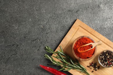 Photo of Different aromatic spices on grey table, flat lay. Space for text