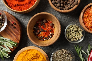 Photo of Different aromatic spices on grey table, flat lay