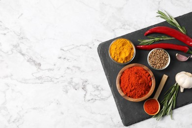 Photo of Different aromatic spices on white marble table, flat lay. Space for text