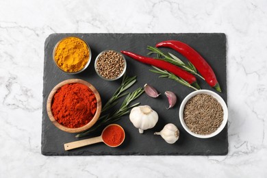 Photo of Different aromatic spices on white marble table, flat lay