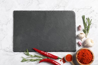 Photo of Different aromatic spices and slate board on white marble table, flat lay. Space for text