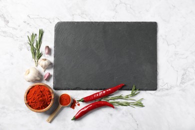 Photo of Different aromatic spices and slate board on white marble table, flat lay. Space for text