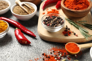 Photo of Different aromatic spices on grey table, closeup