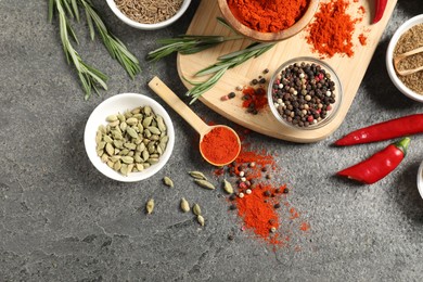 Photo of Different aromatic spices on grey table, flat lay