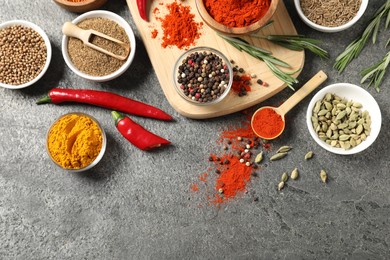 Photo of Different aromatic spices on grey table, flat lay