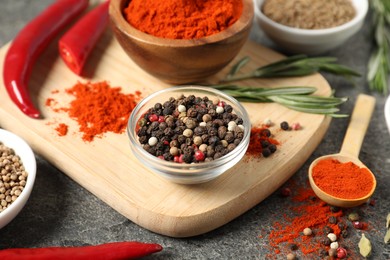 Photo of Different aromatic spices on grey table, closeup
