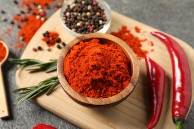 Photo of Different aromatic spices on grey wooden table, above view