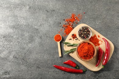 Photo of Different aromatic spices on grey table, flat lay. Space for text