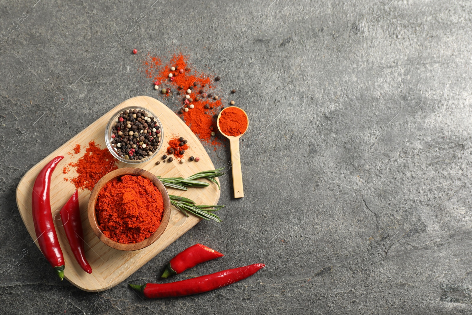 Photo of Different aromatic spices on grey table, flat lay. Space for text