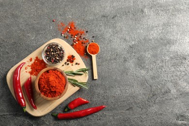Photo of Different aromatic spices on grey table, flat lay. Space for text
