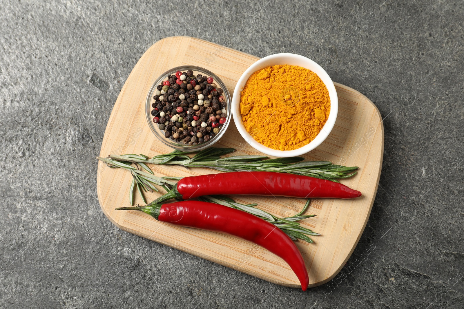 Photo of Different aromatic spices on grey table, top view