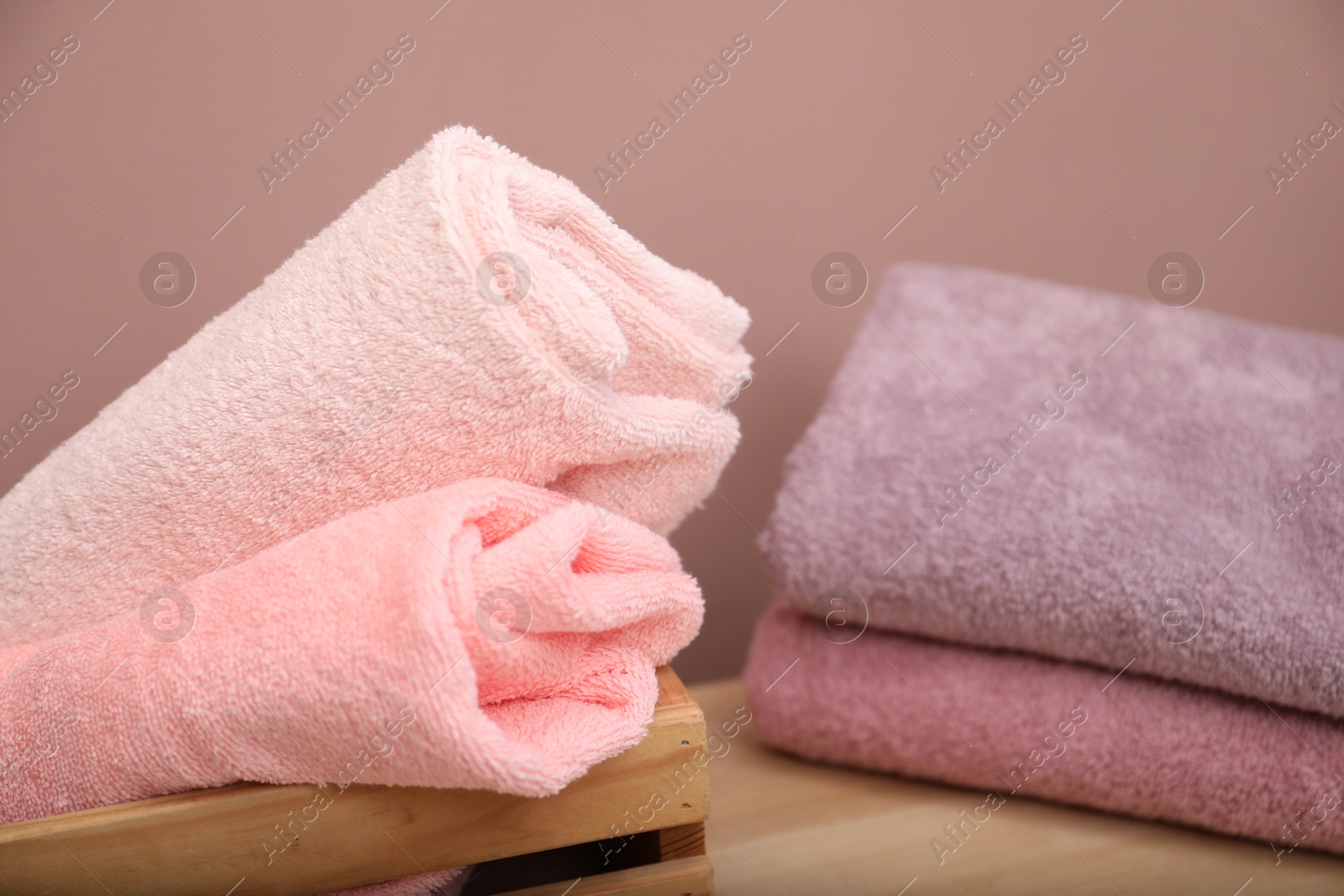 Different colorful towels on table indoors, closeup view Photo of Different colorful towels on table indoors, closeup view