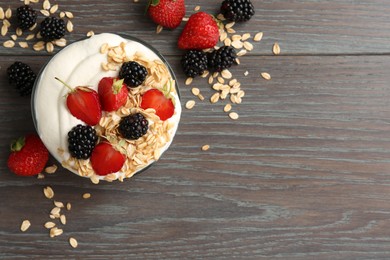 Photo of Tasty yogurt with granola and berries in bowl on wooden table, flat lay. Space for text