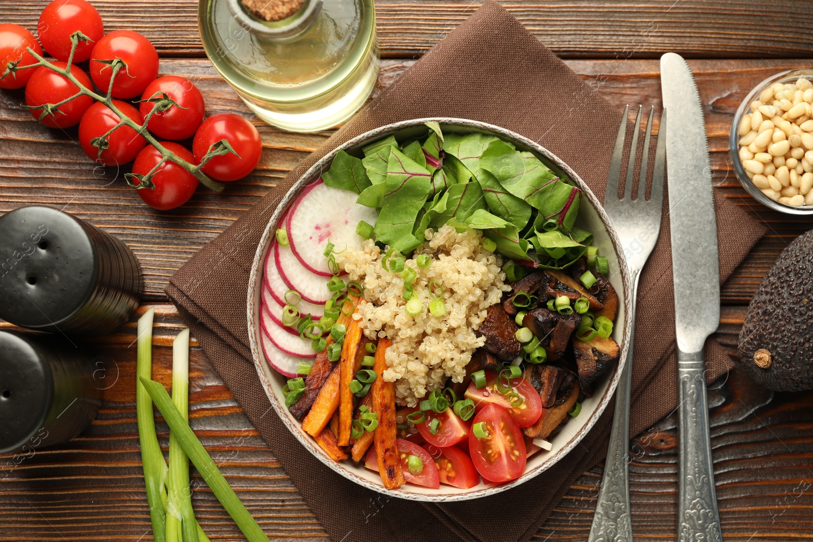 Photo of Healthy vegetarian food. Delicious Buddha bowl and ingredients on wooden table, flat lay