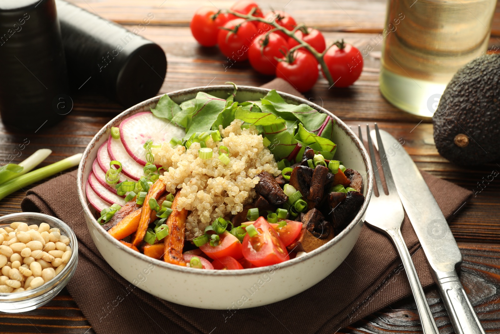 Photo of Healthy vegetarian food. Delicious Buddha bowl and ingredients on wooden table, closeup