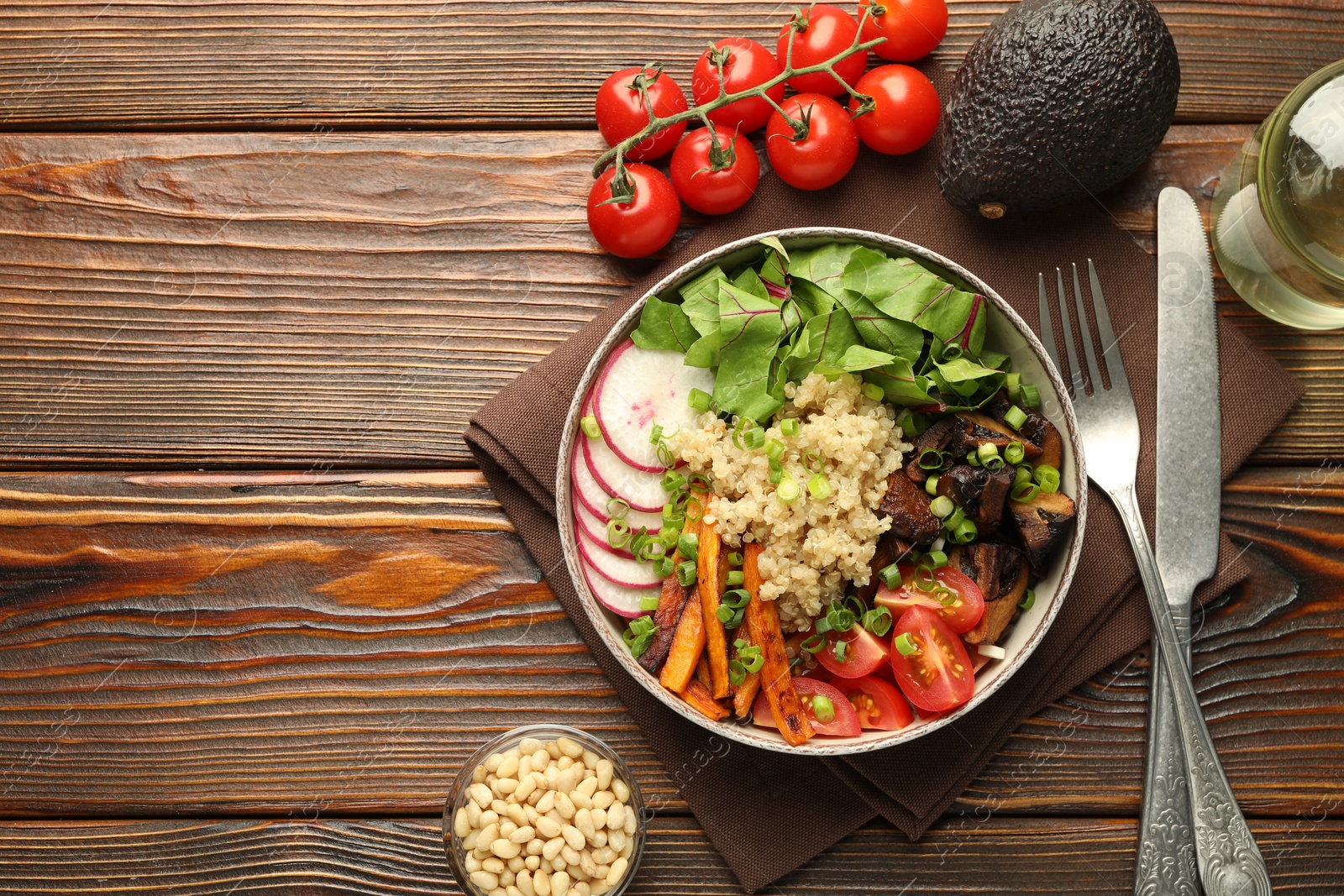 Photo of Healthy vegetarian food. Delicious Buddha bowl and ingredients on wooden table, flat lay. Space for text