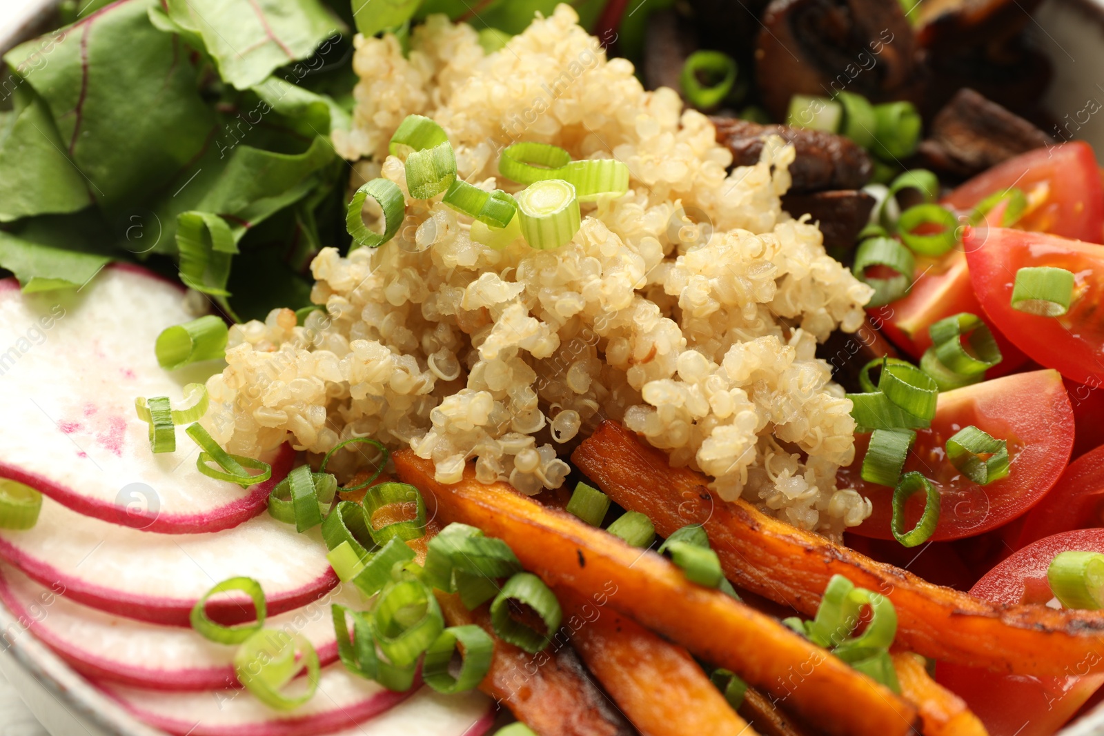 Healthy vegetarian food. Delicious Buddha bowl with quinoa, mushrooms and vegetables as background, closeup Photo of Healthy vegetarian food. Delicious Buddha bowl with quinoa, mushrooms and vegetables as background, closeup
