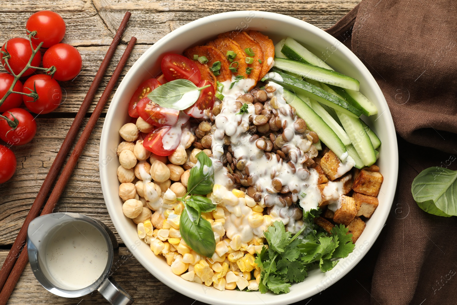 Photo of Healthy vegetarian food. Delicious Buddha bowl served on wooden table, flat lay